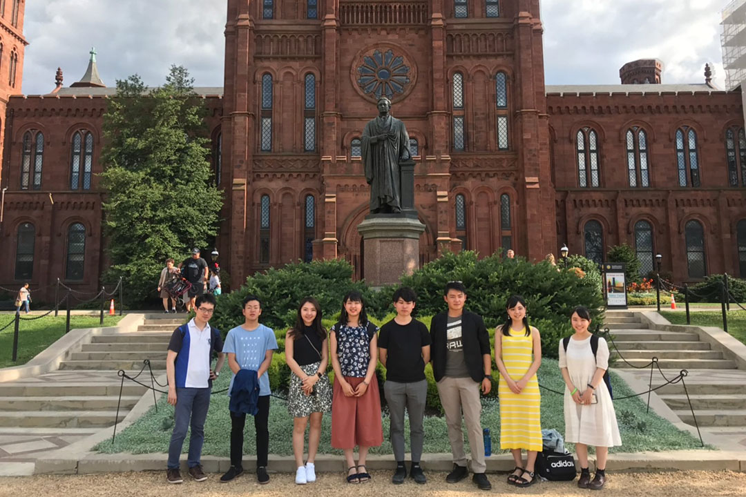Group of Sugai fund students standing outside the Smithsonian Castle