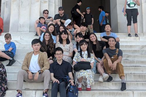 Language Center students sitting on the steps of the Lincoln Memorial