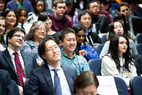 A group of students smiling in the JLive 2018 audience