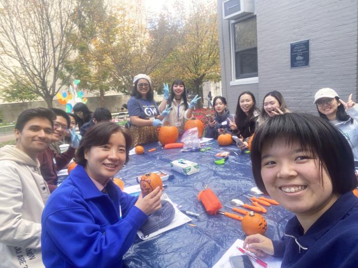 Students carve pumpkins for Halloween